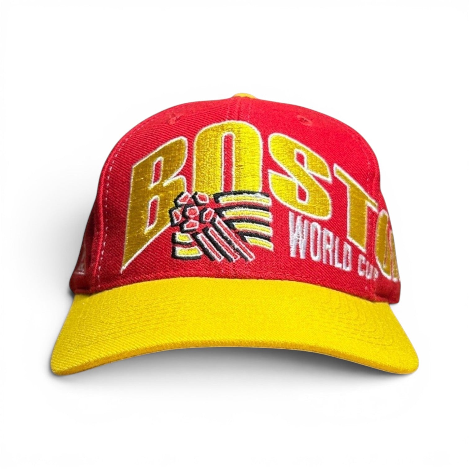 ACOLDWASH red baseball cap with yellow brim and "BOSTON WORLD CUP" embroidered in yellow.