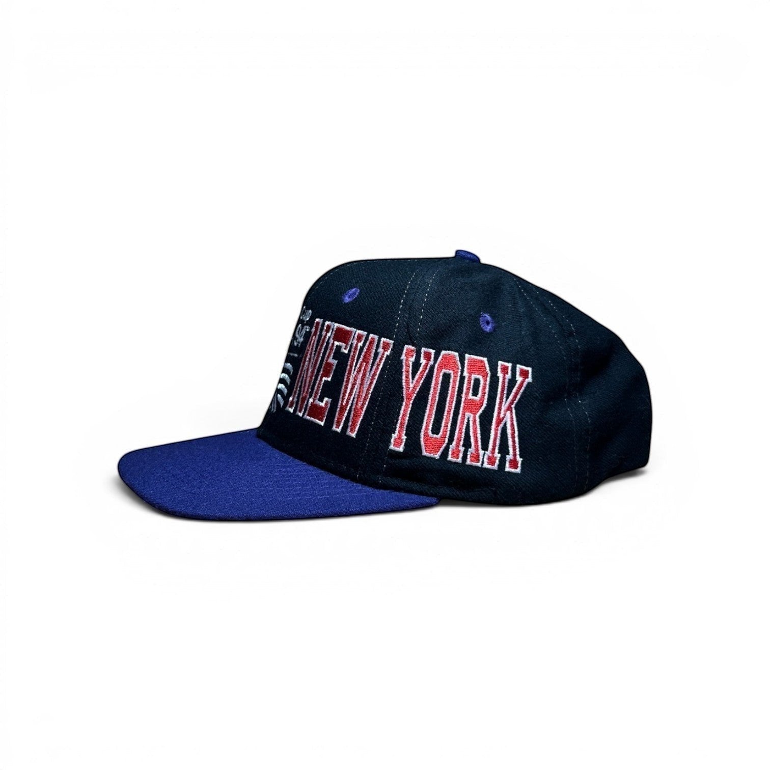 ACOLDWASH navy blue snap cap with a royal blue brim and "NEW YORK" embroidered in red and white.