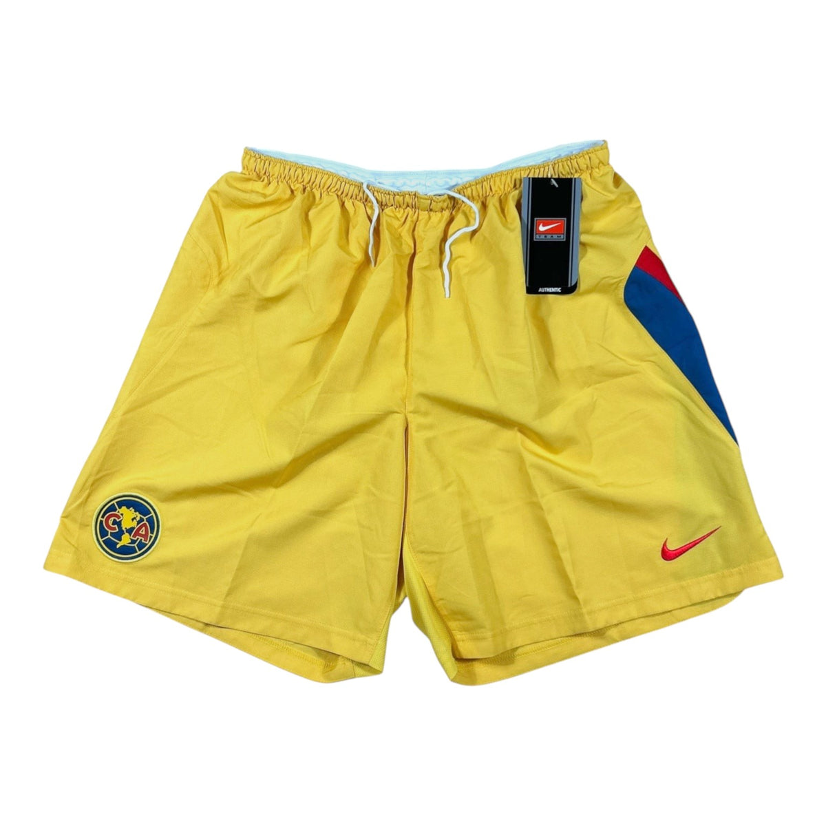 ACOLDWASH vintage 2005-06 Nike Club América yellow football shorts with red and blue side panels and club crest.