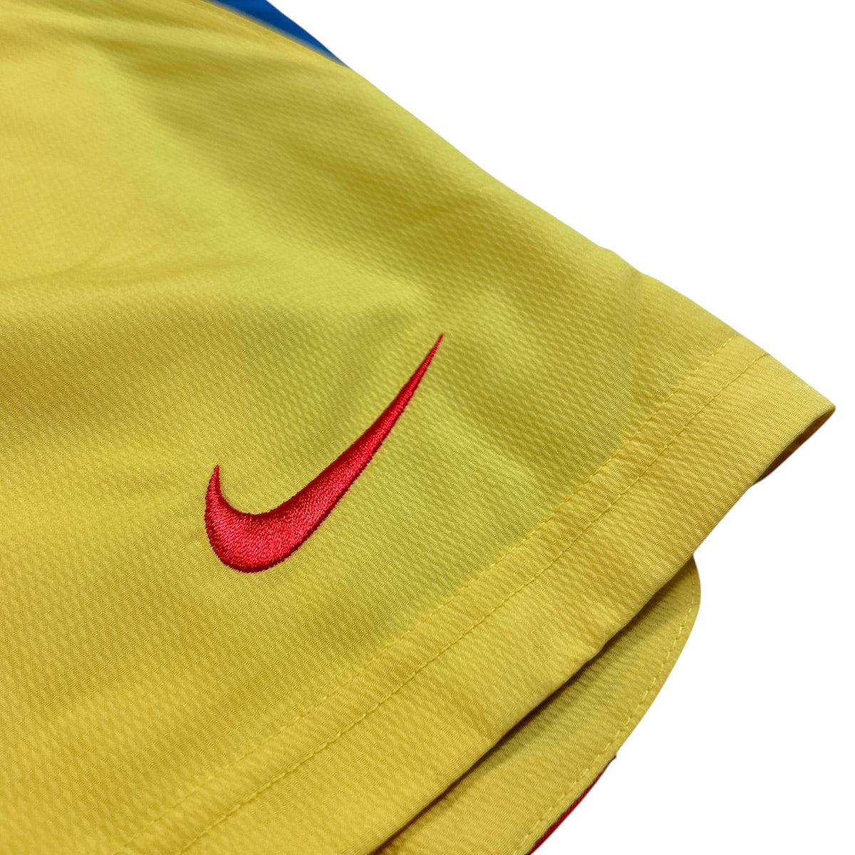 ACOLDWASH vintage 2005-06 Nike Club América football shorts in yellow with an embroidered red Swoosh logo.