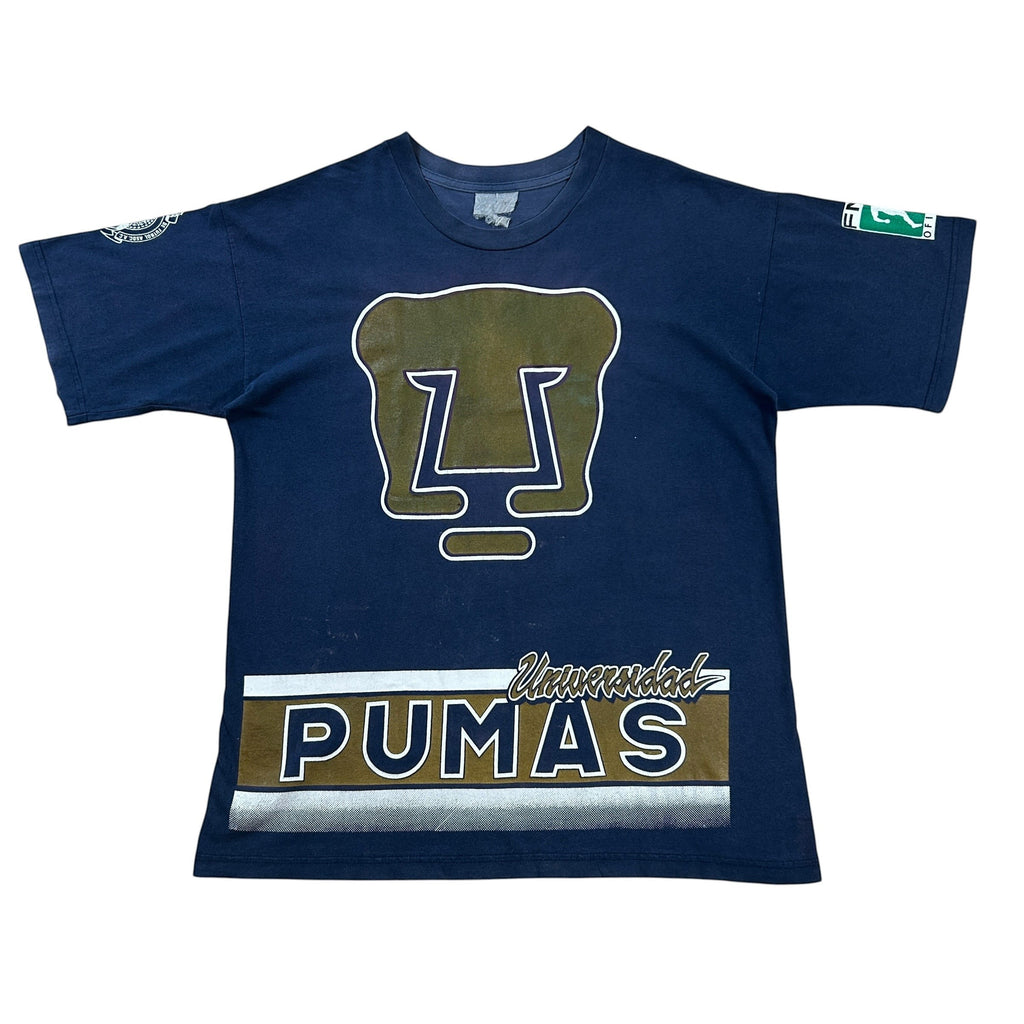 ACOLDWASH navy blue t-shirt with Pumas UNAM logo and text. Features a large Pumas logo on the chest and "PUMAS" text with "Universidad" above it.
