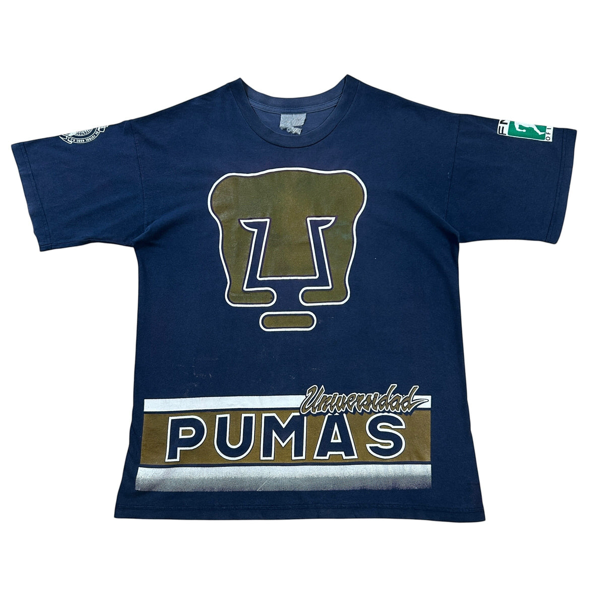ACOLDWASH navy blue t-shirt with Pumas UNAM logo and text. Features a large Pumas logo on the chest and "PUMAS" text with "Universidad" above it.