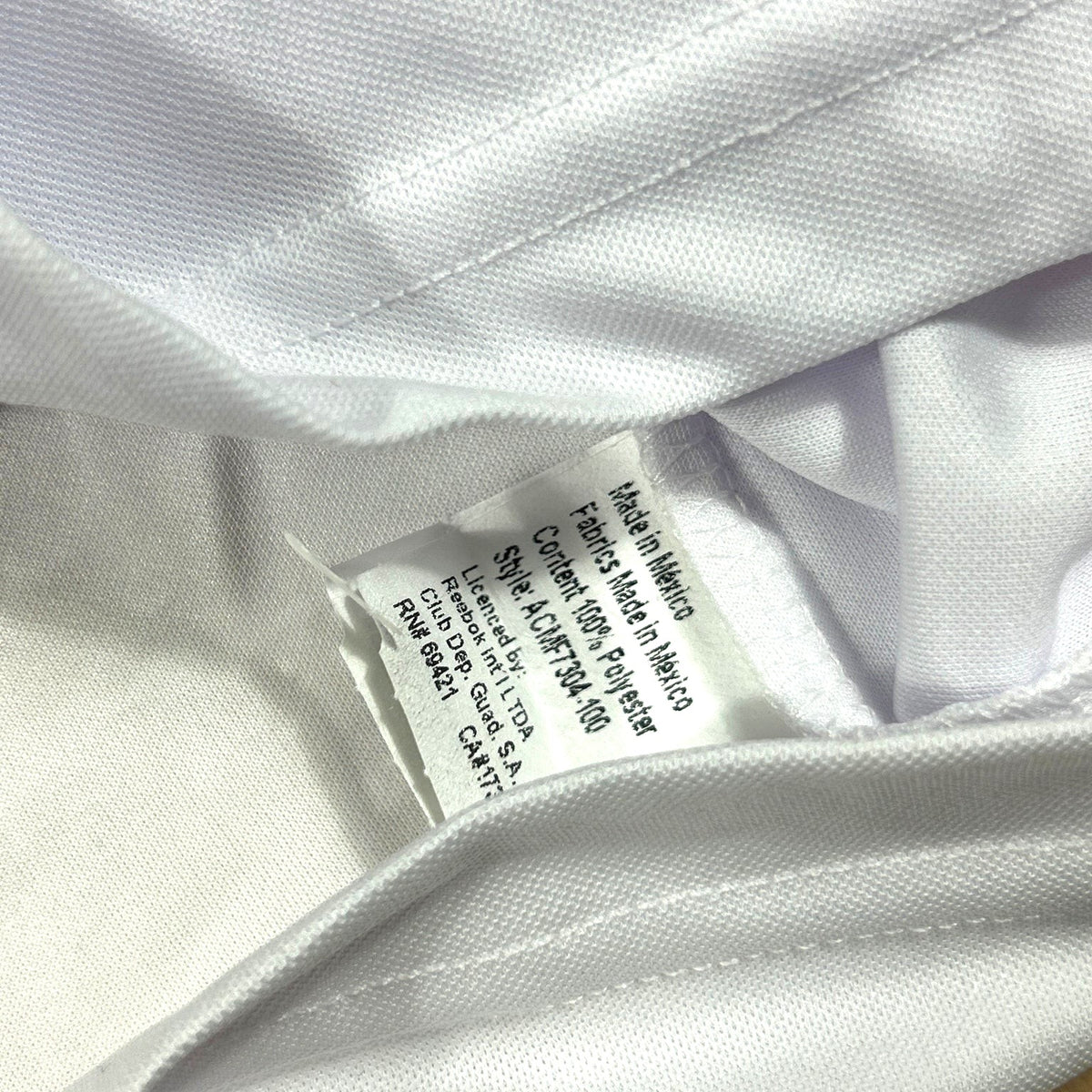 ACOLDWASH vintage Reebok Chivas Guadalajara jersey interior care tag showing polyester material and Mexico origin