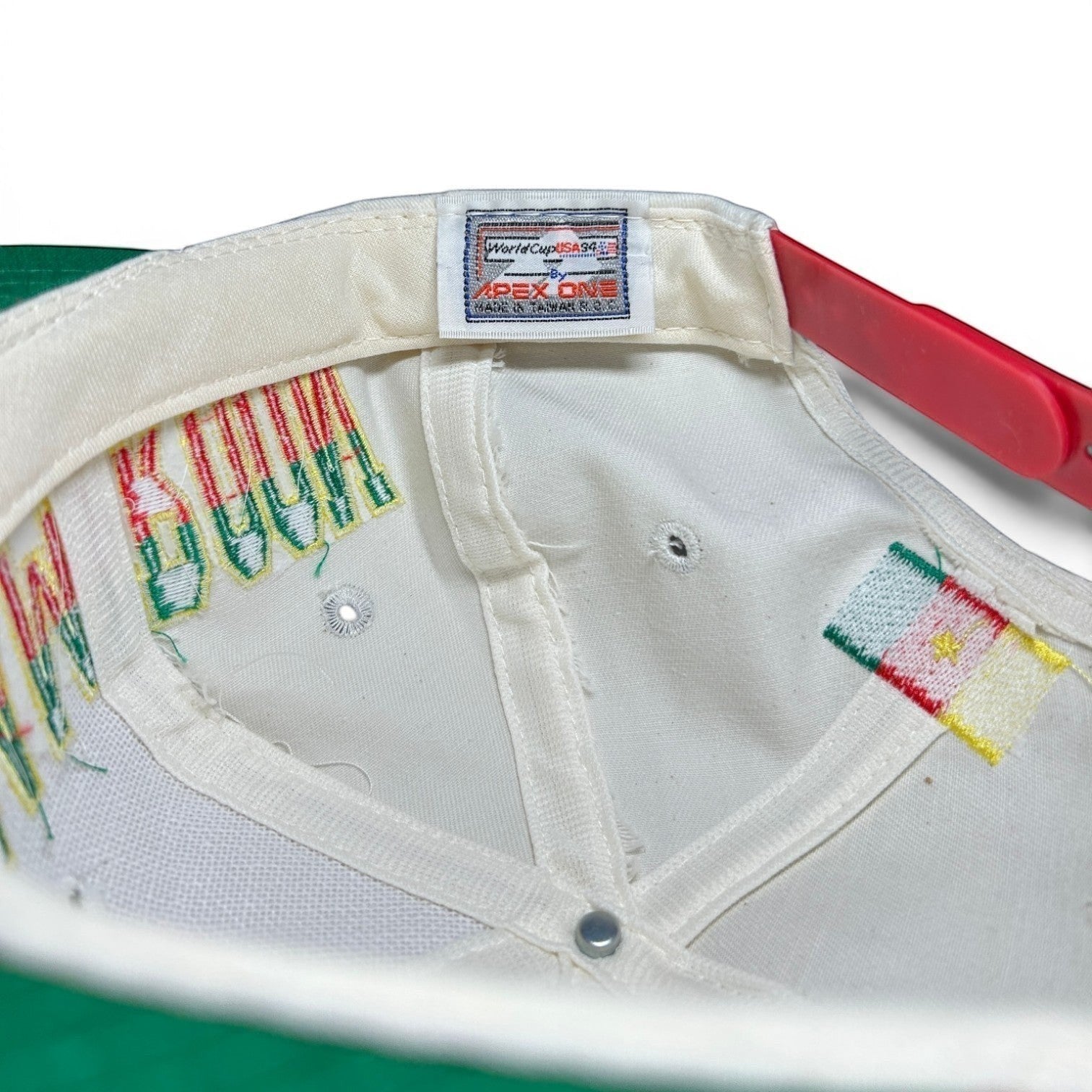 ACOLDWASH USA 94 Cameroon multi snap cap with embroidered text and flag detail.