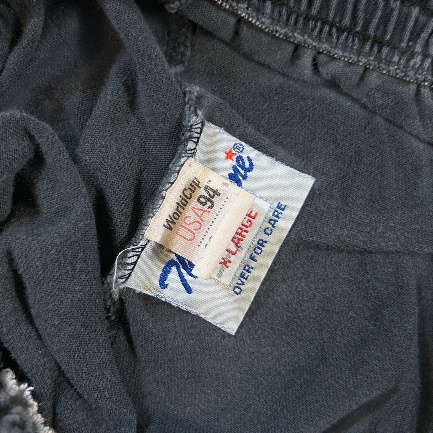 ACOLDWASH charcoal grey shorts with USA 94 World Cup logo tag and The Game brand tag.